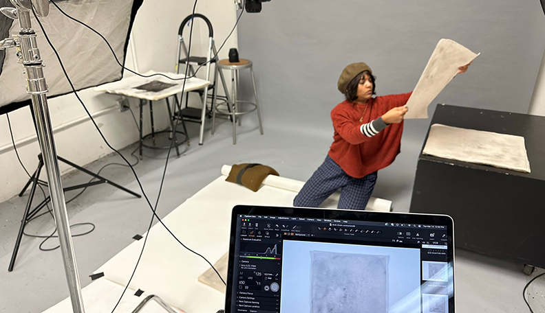 SAAH UIC Photography Lab Student on backdrop